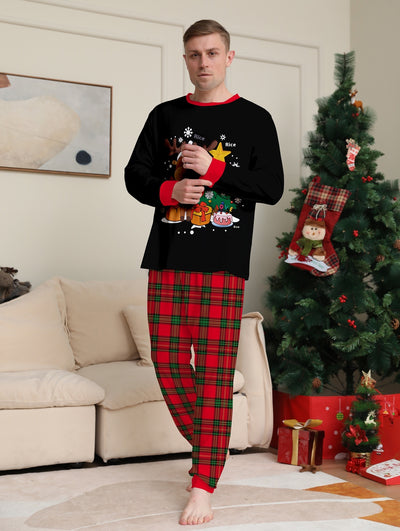 Two children in black and red plaid Christmas pajamas with a reindeer and Christmas tree graphic, standing by a Christmas tree. - Image 11