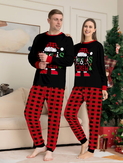 Man wearing black and red plaid Christmas pajamas with a Santa graphic top and matching pants. - Image 4