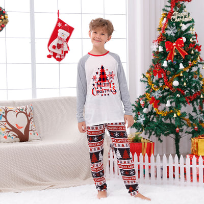 Family of four wearing matching Christmas pajamas with 'MERRY Christmas' text, leopard print, and plaid trees. - Image 21