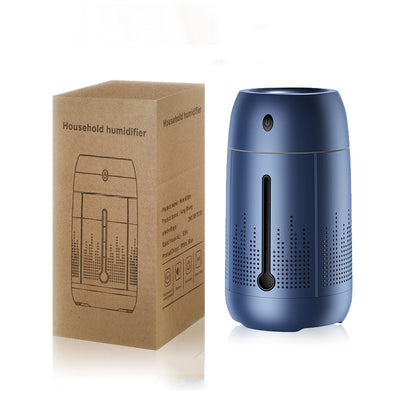 White cylindrical household humidifier with a visible water level indicator, next to its brown cardboard packaging. - Image 8