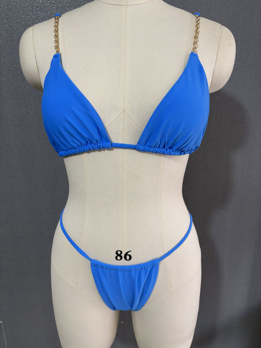 White three-point bikini with gold chain straps on a mannequin, featuring a triangle top and thong bottom. - Image 7