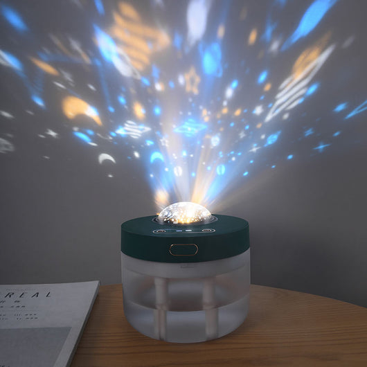White portable projection humidifier with a translucent water tank and gold-accented control buttons. - Image 2