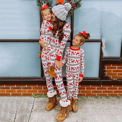 Mother and two daughters in matching red and white reindeer and snowflake print long-sleeve Christmas pajamas. - Image 3