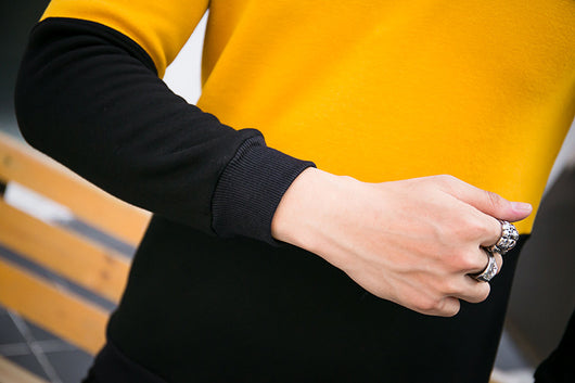 Men's white and yellow color block long-sleeve top with a crew neck and circular embroidered patch on the chest. - Image 11