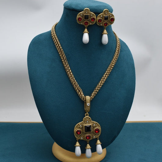 Vintage gold-toned necklace with double chain, ornate pendant featuring red and black glass inlays, and three white pearl tassels. - Image 2