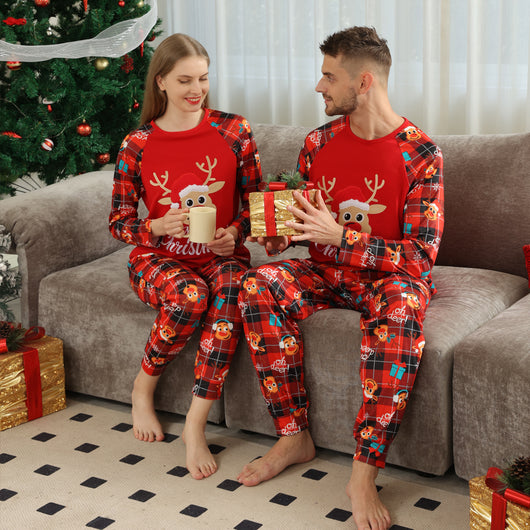 Family matching red Christmas pajamas with a cartoon reindeer and "Merry Christmas" text on a plaid background. - Image 19