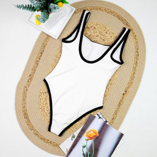 Woman in a white one-piece swimsuit with black trim and decorative buttons, sitting on a boat. - Image 15