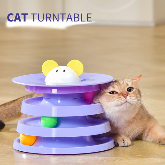 Brown tabby cat sniffing a black and orange multi-level rotating cat plate toy with colorful balls and bunny ears. - Image 5