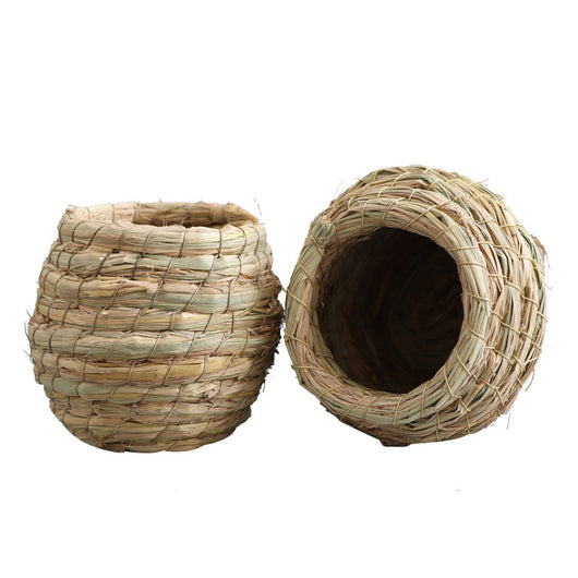 Hand-woven straw bird nest with a round entrance, designed for small birds and pets, shown with a colorful bird flying towards it. - Image 6