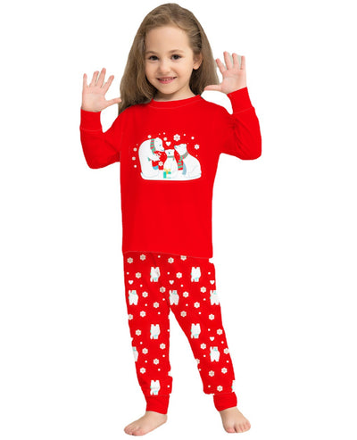 Family of four in matching red Christmas pajamas with polar bear and snowflake print, standing by a Christmas tree. - Image 11