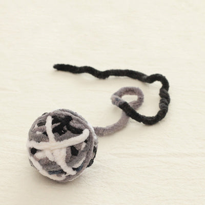 Colorful plush yarn ball cat toy in pink, blue, and white, with a long trailing strand, on a light background. - Image 22