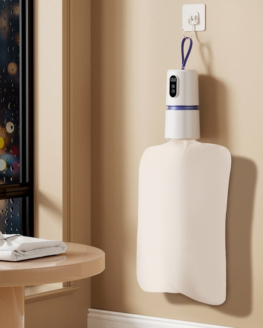White and blue mini household air dryer with a digital display and hanging loop, shown next to a gold smartphone. - Image 9