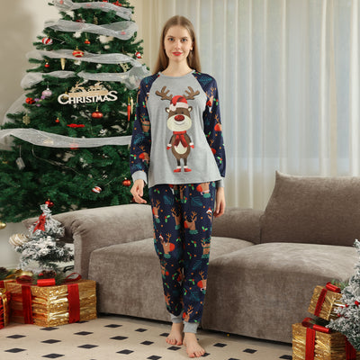 Family Christmas pajamas with a cartoon reindeer wearing a Santa hat and red scarf on a black top, and dark blue pants with a repeating reindeer and holly patte - Image 13