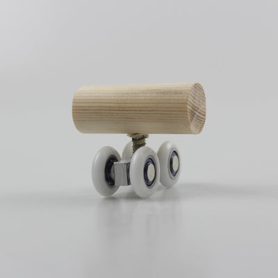 Wooden bird toy resembling a roller skate with a pine log body and four white wheels with metal bearings. - Image 4