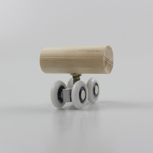 Wooden bird toy resembling a roller skate with a pine log body and four white wheels with metal bearings. - Image 4