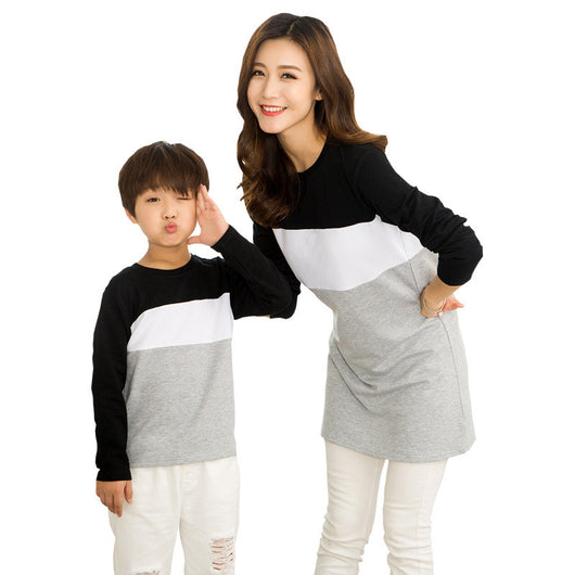 Matching black, white, and grey colorblock long-sleeved t-shirts for couples, worn by a man and a woman. - Image 5