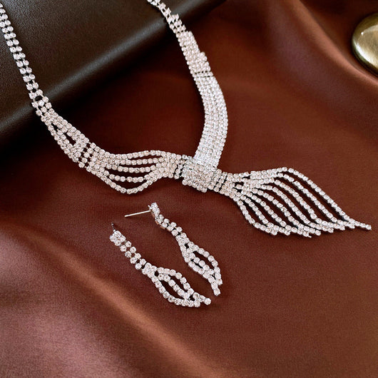 Gold-tone rhinestone necklace and matching dangle earrings set. The necklace features a multi-strand, leaf-like design. - Image 7