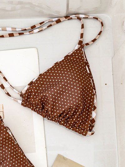 Retro brown and white plaid triangle bikini top with matching polka-dot bottoms, displayed flat with accessories. - Image 16