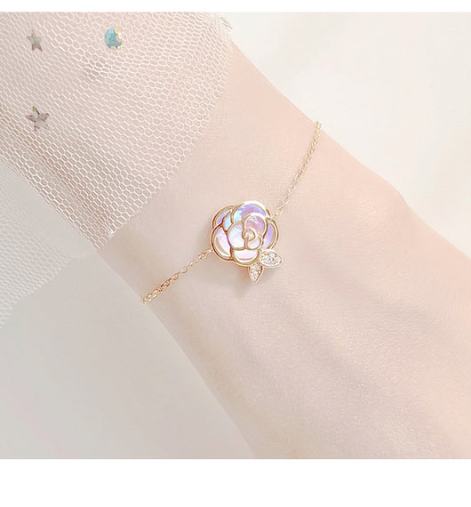 Gold-tone necklace with an iridescent camellia flower pendant and small clear stones on a delicate chain. - Image 14
