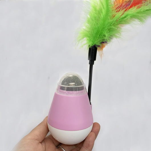 Pink and white tumbler cat toy with a clear dome revealing a catnip ball and a colorful feather wand. - Image 8
