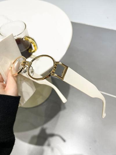 Retro small frame sunglasses with gold round frames and leopard print temples, held by a hand. - Image 7