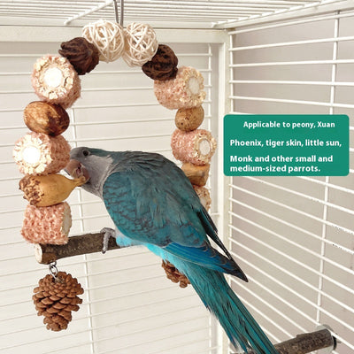Natural wooden parrot swing with an arched top made of corn cobs, seed pods, and woven balls, featuring a log perch and two hanging pine cones. - Image 12