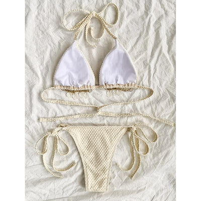 White halter lace-up bikini with a textured pattern, styled with a straw hat and gold jewelry on a sandy background. - Image 3