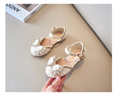 Beige girls' shallow mouth pumps with a large pink pearl bow, glitter, and an ankle strap with a gold buckle. - Image 12