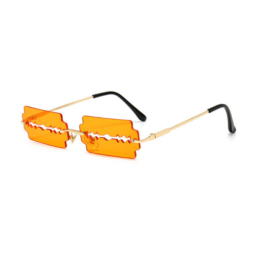 Orange razor blade shaped rimless sunglasses with gold metal frames and black ear tips on a white background. - Image 11