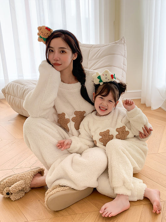 Mother and child in matching off-white coral velvet pajamas with brown cartoon bears, sitting on a black couch. - Image 3