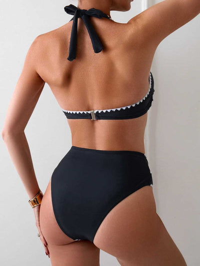 Black two-piece swimsuit with white scalloped trim, featuring a halter neck wrap-front top and high-waisted bottoms. - Image 4