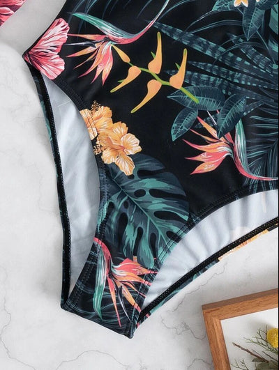 Women's pink long-sleeve one-piece swimsuit with a vibrant tropical leaf and floral print. - Image 11