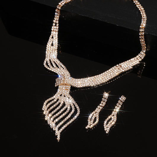 Gold-tone rhinestone necklace and matching dangle earrings set. The necklace features a multi-strand, leaf-like design. - Image 13