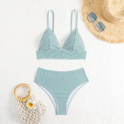 Green and white striped two-piece bikini with a triangle top and high-waisted bottoms on a woman. - Image 17