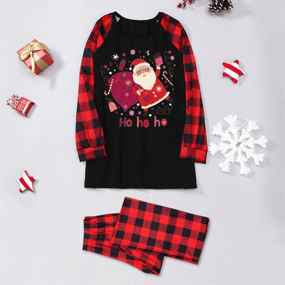 Family matching Christmas pajamas with black tops featuring a Santa graphic and red buffalo plaid sleeves and pants. - Image 4