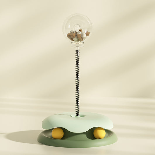 Mint green and dark green cat leakage food toy with a clear spherical treat dispenser on a black spring. - Image 18