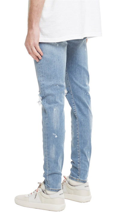Jeans Slim Fit Azul con Corte en Rodilla y Diseño Spray Pintado - Image 13