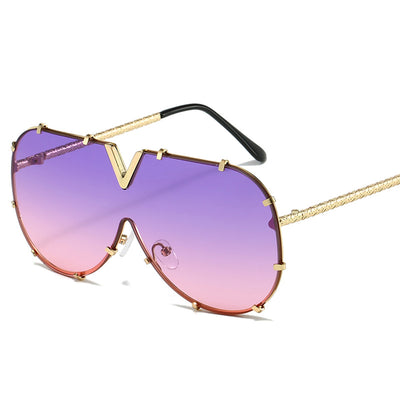 Oversized V-shaped sunglasses with a gold metal frame, white accents, clear lenses, and decorative rivets. - Image 5