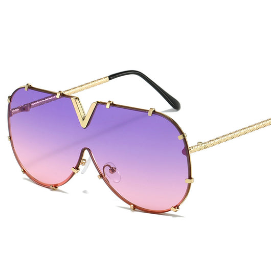 Oversized V-shaped sunglasses with a gold metal frame, white accents, clear lenses, and decorative rivets. - Image 5