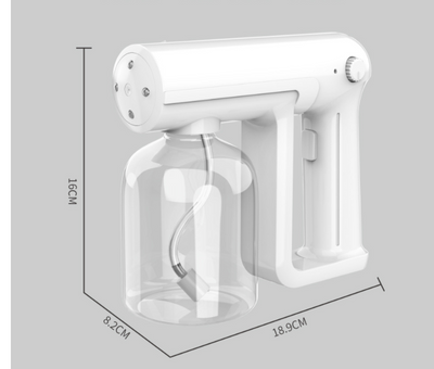 Black wireless alcohol blue light disinfection spray gun with clear reservoir, actively misting, on a marble surface. - Image 9