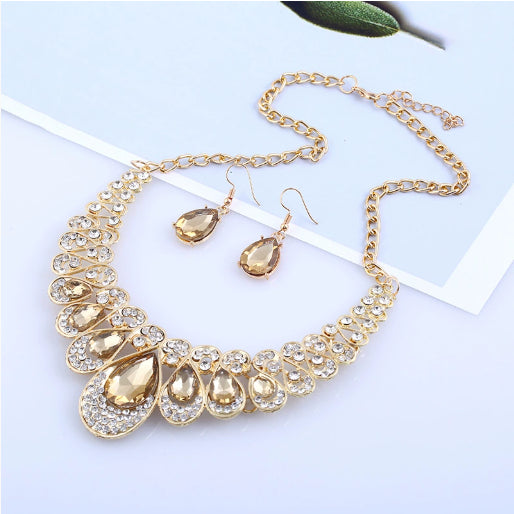 Gold-tone necklace and matching drop earrings set with clear teardrop gems and sparkling rhinestones. - Image 10