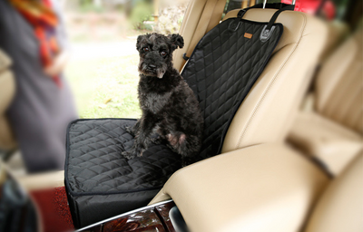 Black quilted waterproof pet seat cover and booster pad installed in a beige car, with a black dog sitting on it. - Image 10