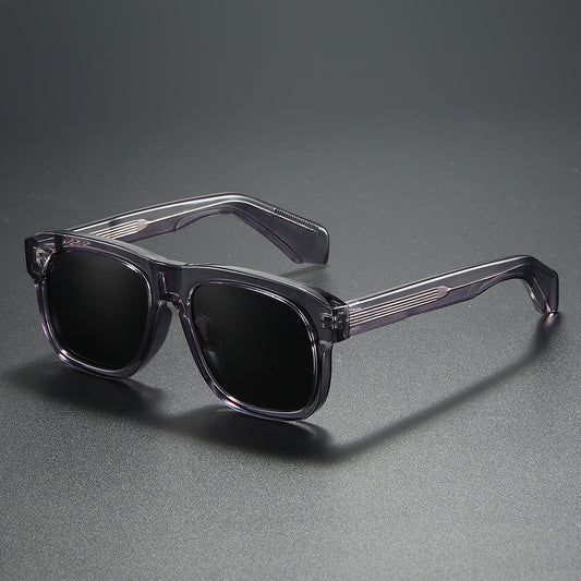 Black square-frame polarized sunglasses with dark lenses, suitable for both men and women, on a dark gray surface. - Image 2