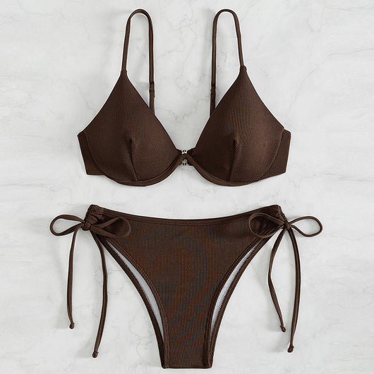 Black ribbed two-piece bikini with an underwire top and tie-side bottoms on a white marble surface.