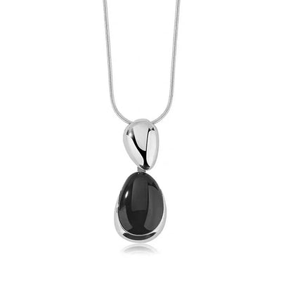 Pair of gold-toned irregular earrings with black onyx-like inserts, featuring a modern, abstract design. - Image 28