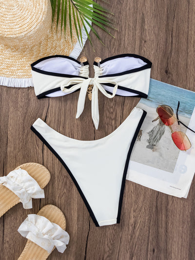 Women's white and black color-contrast tube top bikini with gold-tone hardware, modeled by a pool. - Image 18