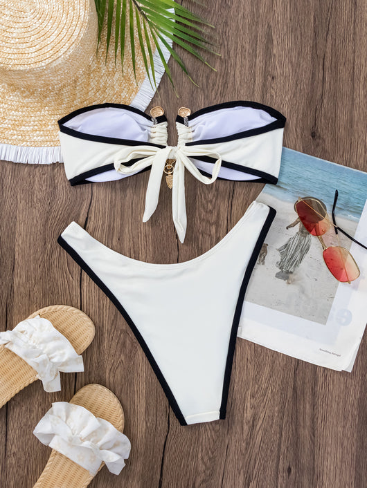 Women's white and black color-contrast tube top bikini with gold-tone hardware, modeled by a pool. - Image 18