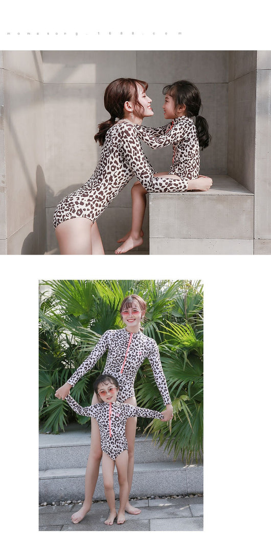 Child's long-sleeve leopard print swimsuit with a coral zipper and a matching swim cap on a white background. - Image 9