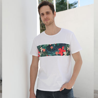 Child's white short-sleeve t-shirt with a horizontal tropical leaf and orange flower print band across the chest. - Image 11
