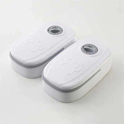 White automatic pet feeder with a pink timer dial and an embossed paw print on the lid. - Image 22
